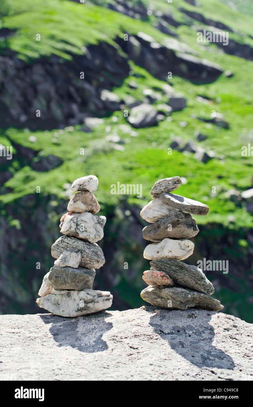 Stone towers. Two pyramid of meditation zen stones on mountains landscape Stock Photo
