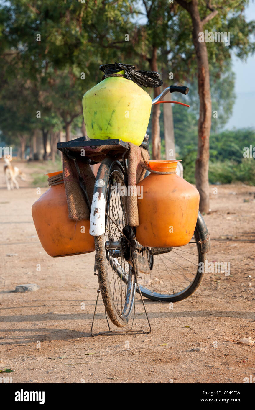 Indian bicycle with pots for collecting food waste in a rural indian village. Andhra Pradesh, India Stock Photo