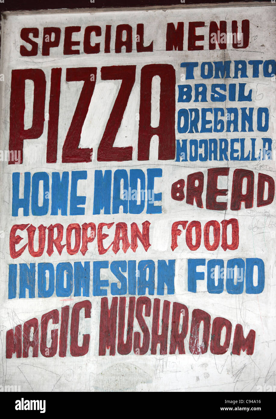 Sign outside restaurant advertising food as well as magic mushrooms. Stock Photo