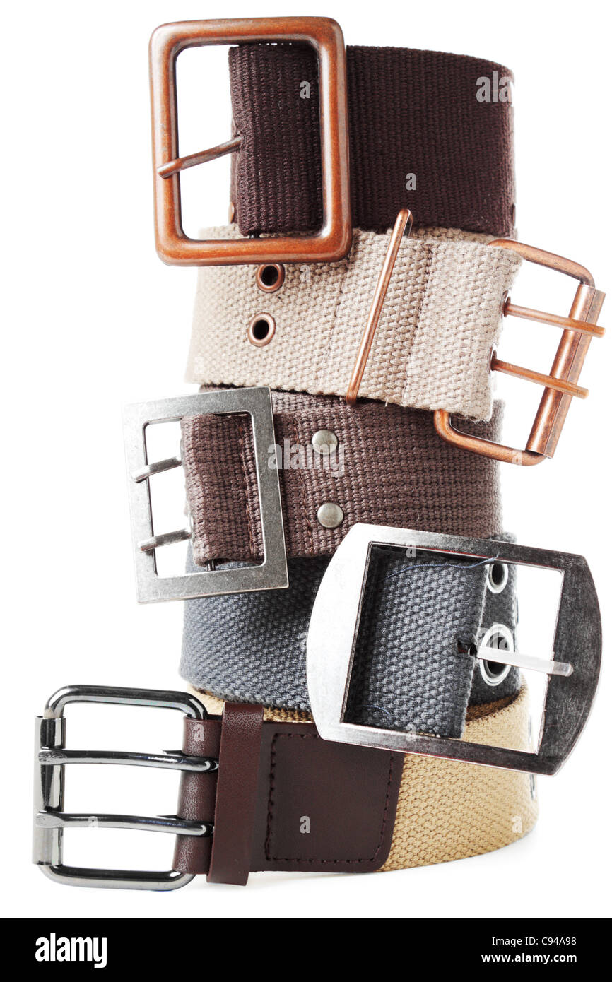 Five textile belts with metal buckles grouped in stack. Isolated over white background Stock Photo
