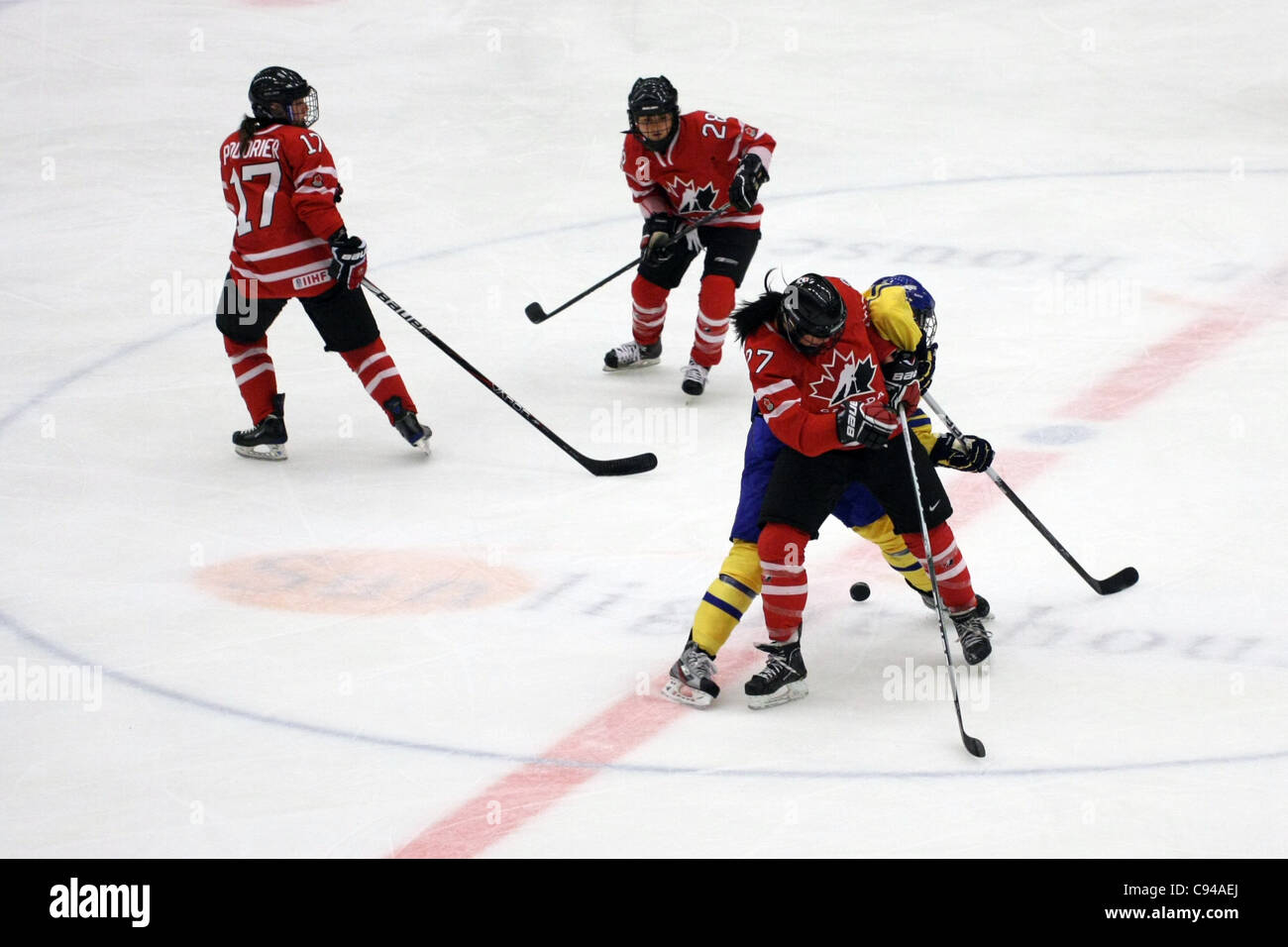 Canadas #27 Jesse Scanzano fighting for the puck with Swedens #2 Elin Holmlöv. The game between Sweden and Canada ended 1-3 in the tournament in Nyköping, Sweden. Stock Photo