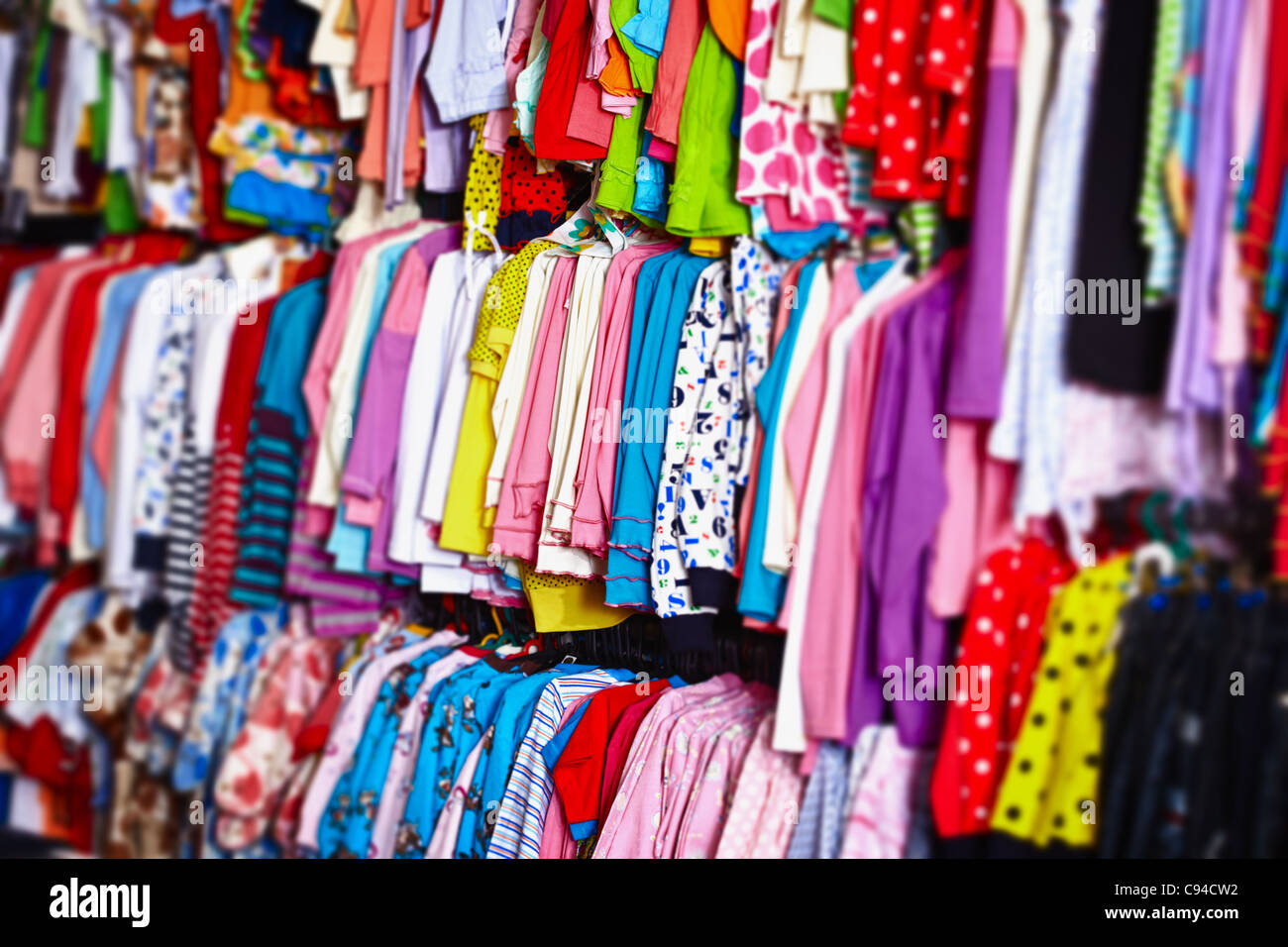 Colorful Baby Clothes Hanging On Hangers In A Store Stock Photo