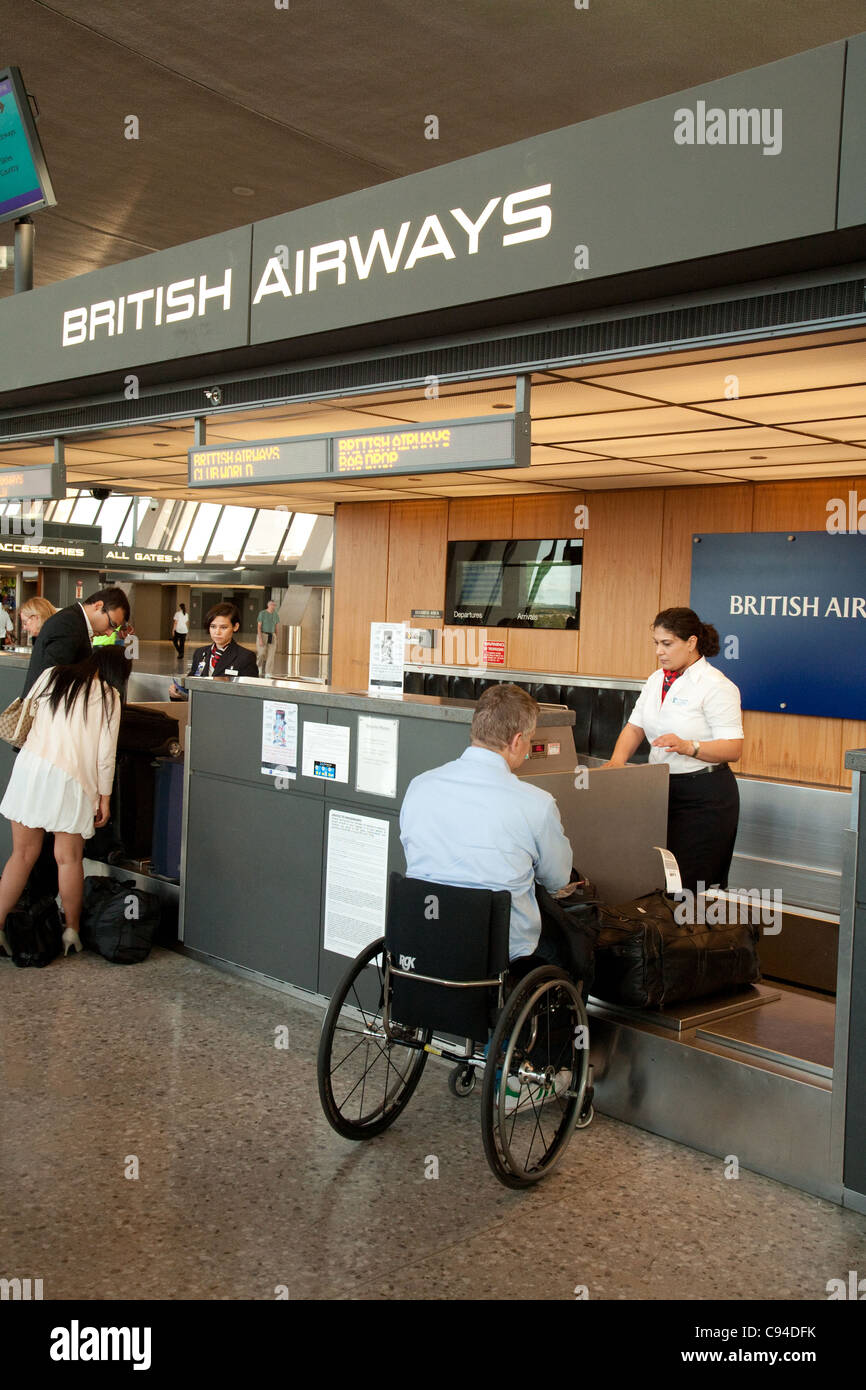 Disabled passenger in a wheelchair checking in at the British Airways bag drop, Dulles IAD