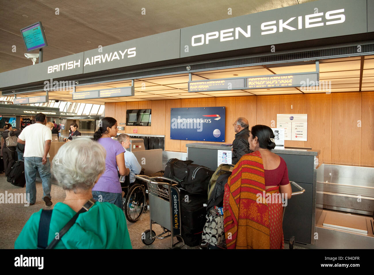 Passengers checking in at the British Airways bag drop, Dulles IAD airport, Washington DC USA Stock Photo