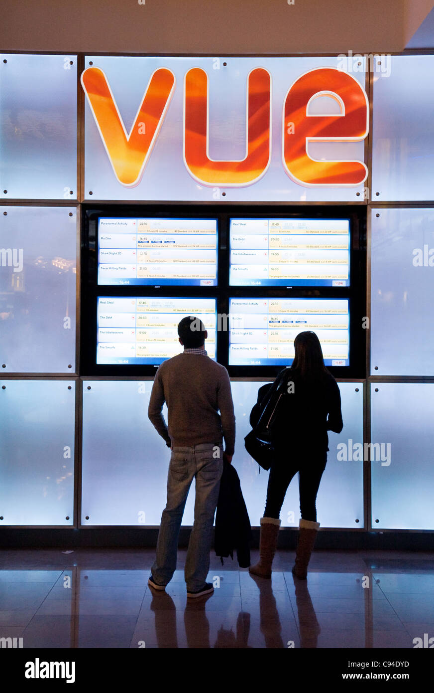 A couple looking at the signs at a Vue Cinema, Westfield shopping centre, Stratford UK Stock Photo