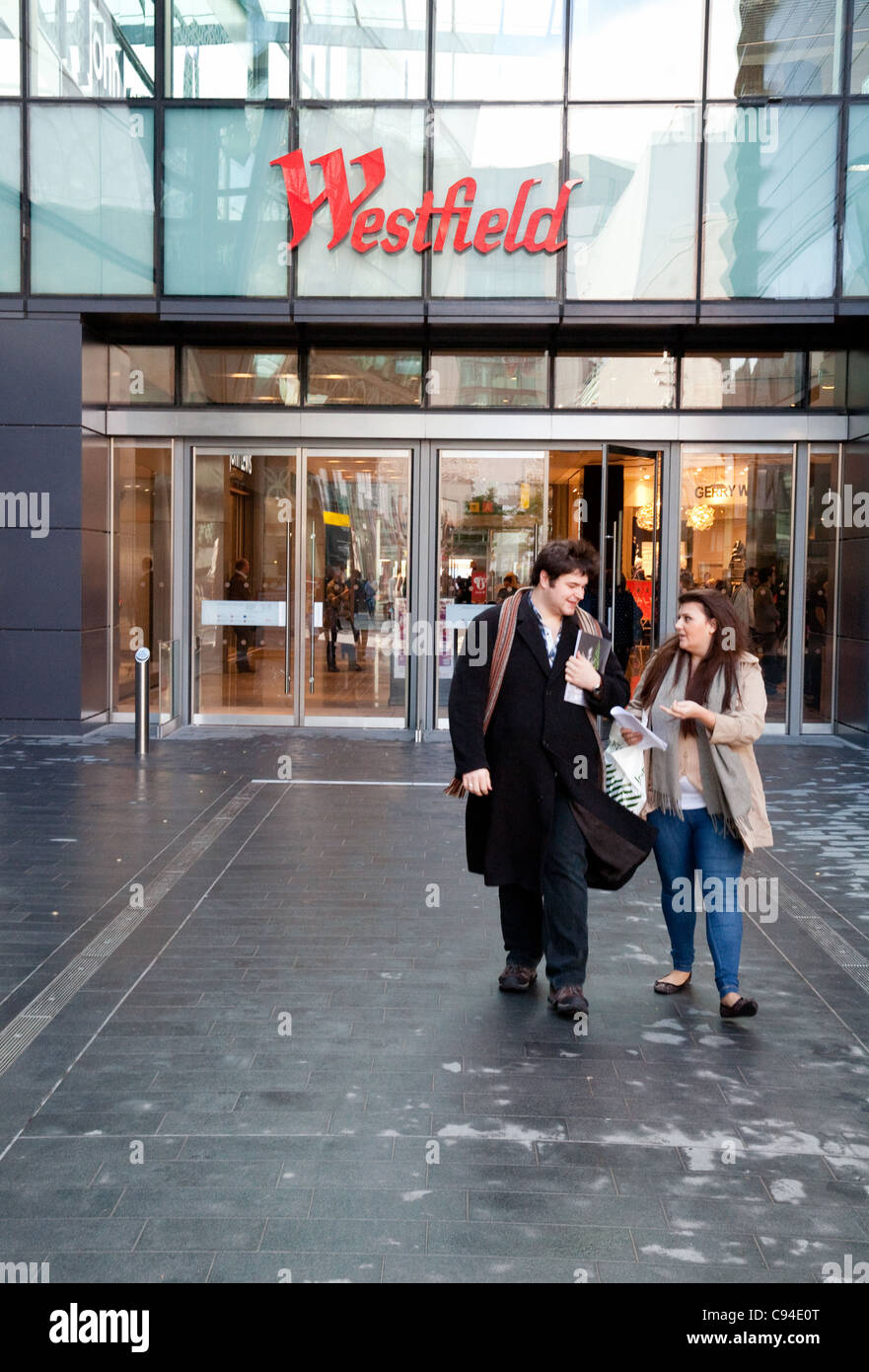 A couple at the entrance to Westfield shopping centre, Stratford, London UK Stock Photo
