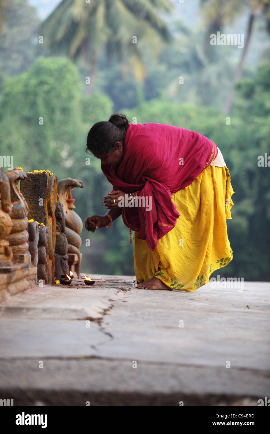 woman worshiping a Shiva snake Arunachala Tamil Nadu India Stock Photo