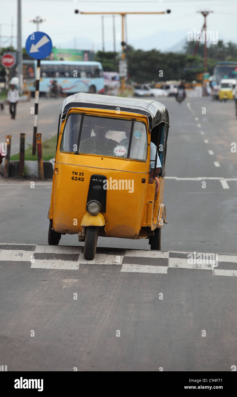 Rickshaw passing a speed breaker Tamil Nadu India Stock Photo