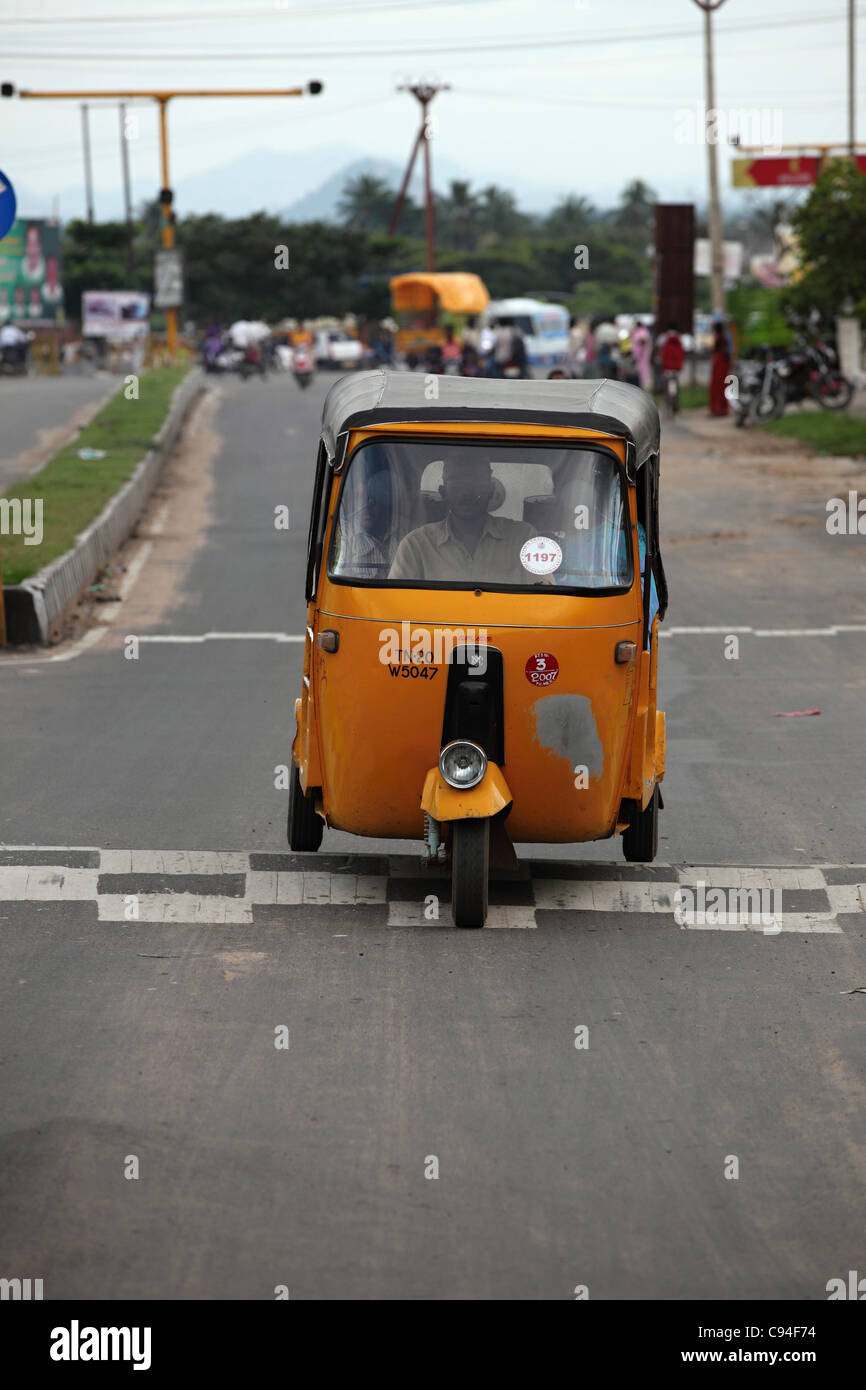 Rickshaw passing a speed breaker Tamil Nadu India Stock Photo