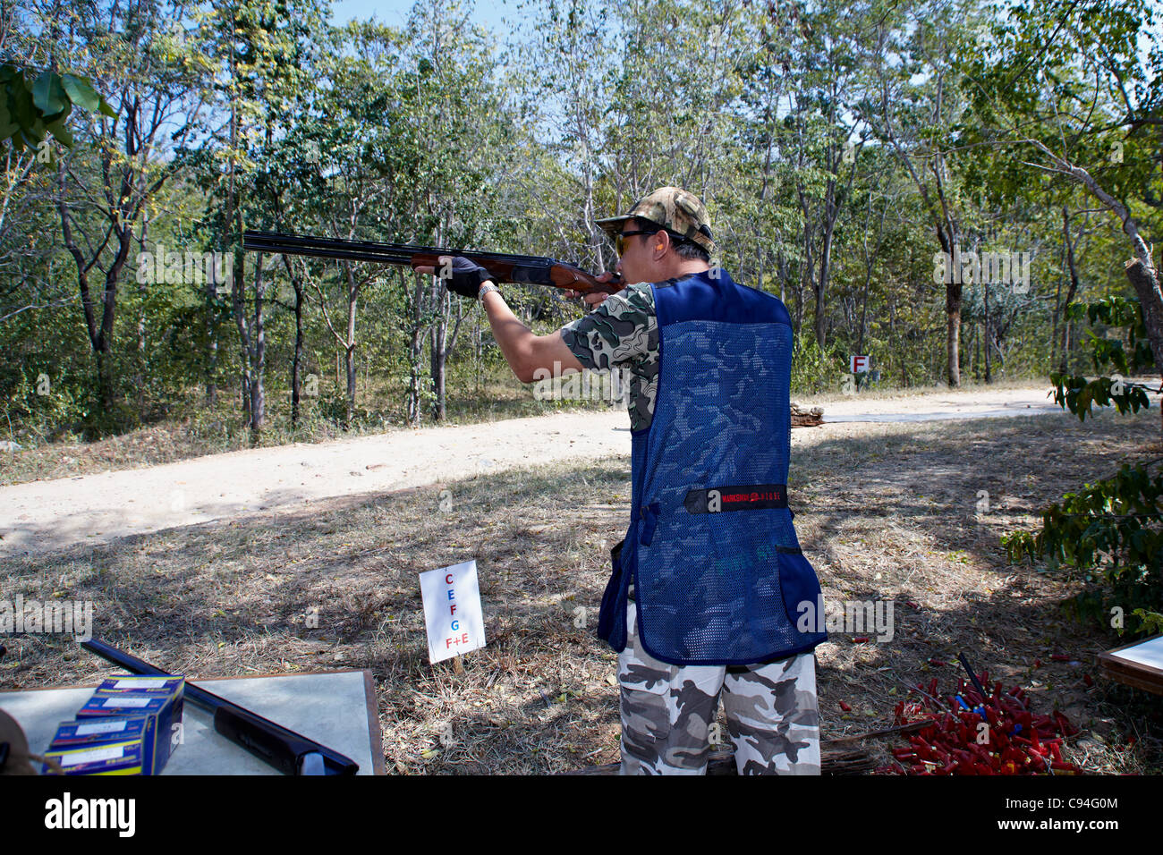 Clay pigeon shooting, Man using a shotgun  taking aim at a clay pigeon shoot Stock Photo