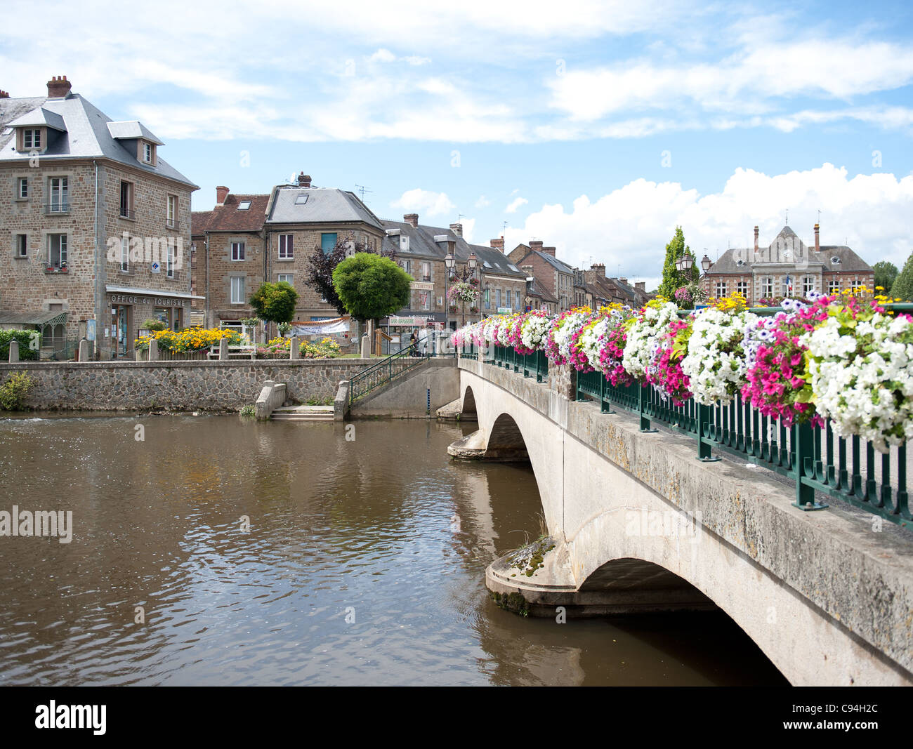 Town centre with mairie (right) of Putanges-Pont Écrepin with bridge over Orne river in Basse Normandie, Lower Normandy, France Stock Photo