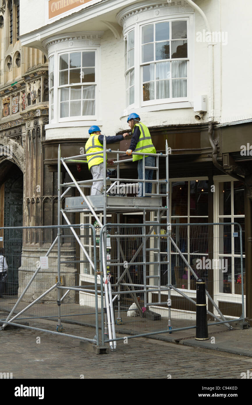 Two workmen working on a tower scaffold Stock Photo