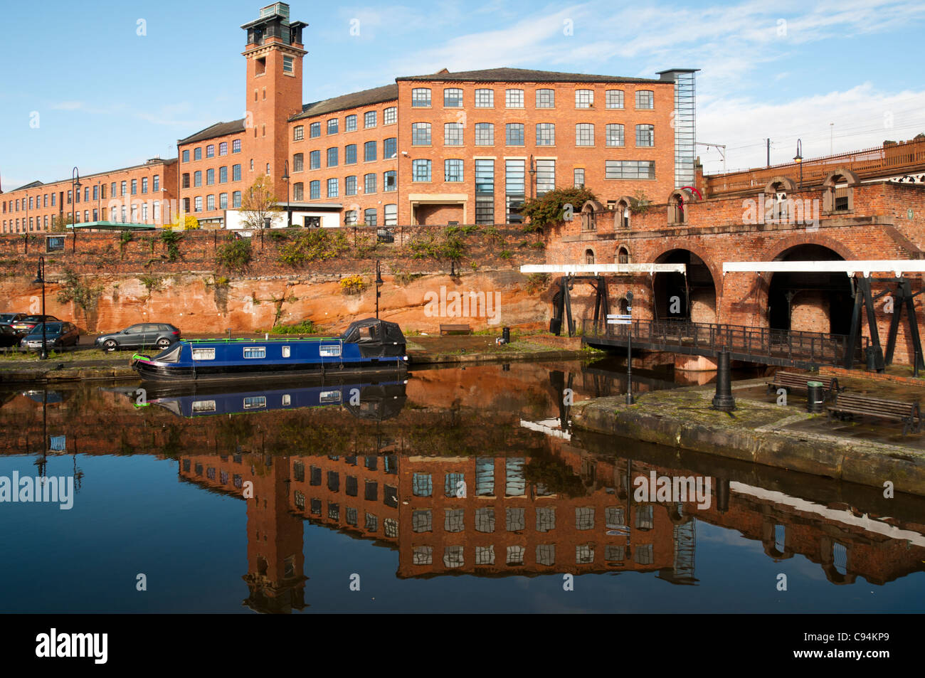 Narrowboat on the Bridgewater Canal at Castlefield Basin, Manchester, England, UK. The Eastgate building behind. Stock Photo