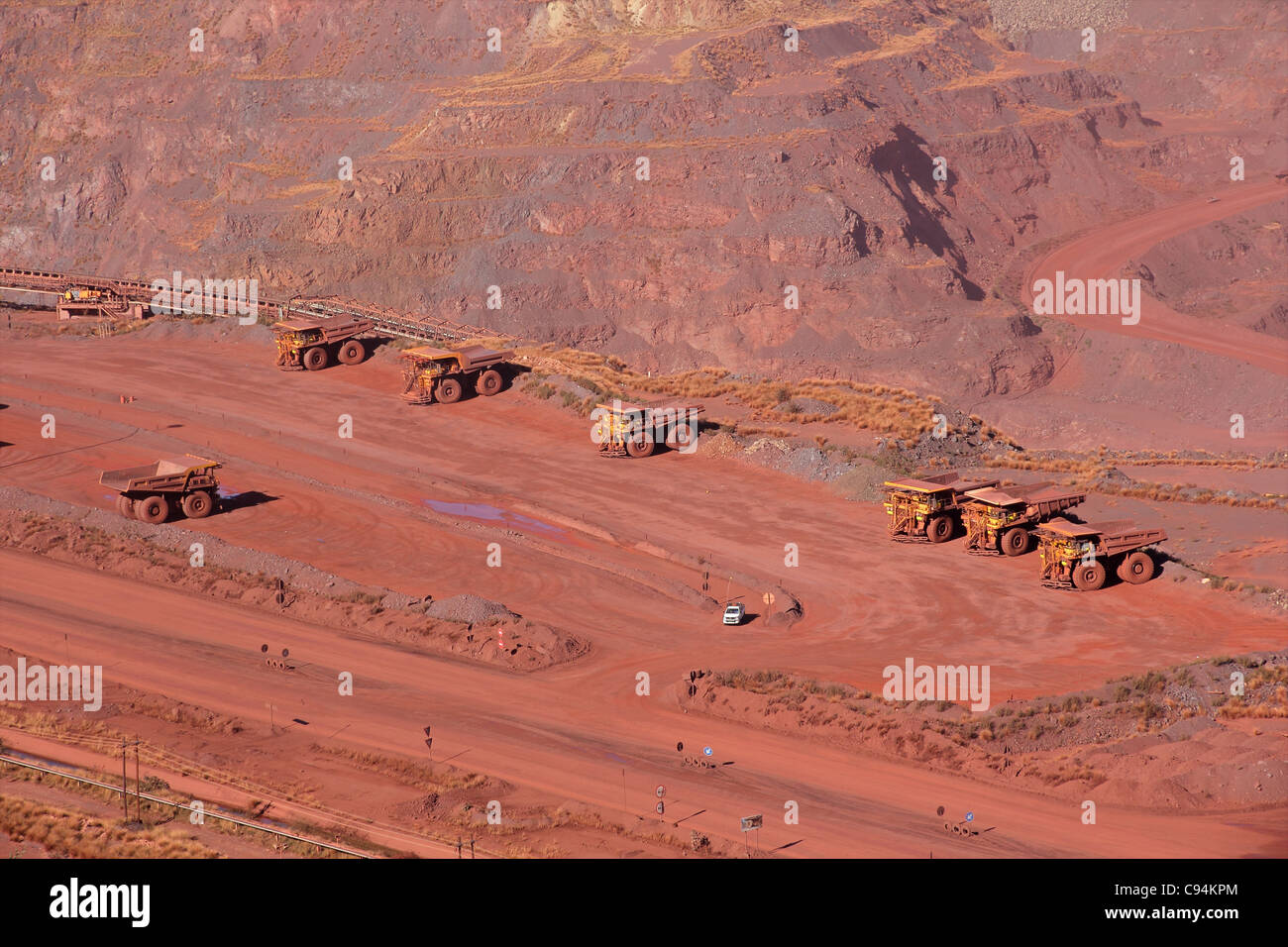 Large, open-pit iron ore mine with trucks Stock Photo