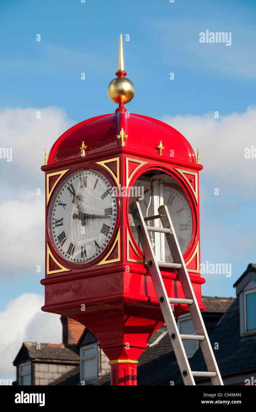 Erecting the town clock after refurbishment, in Villemomble Square