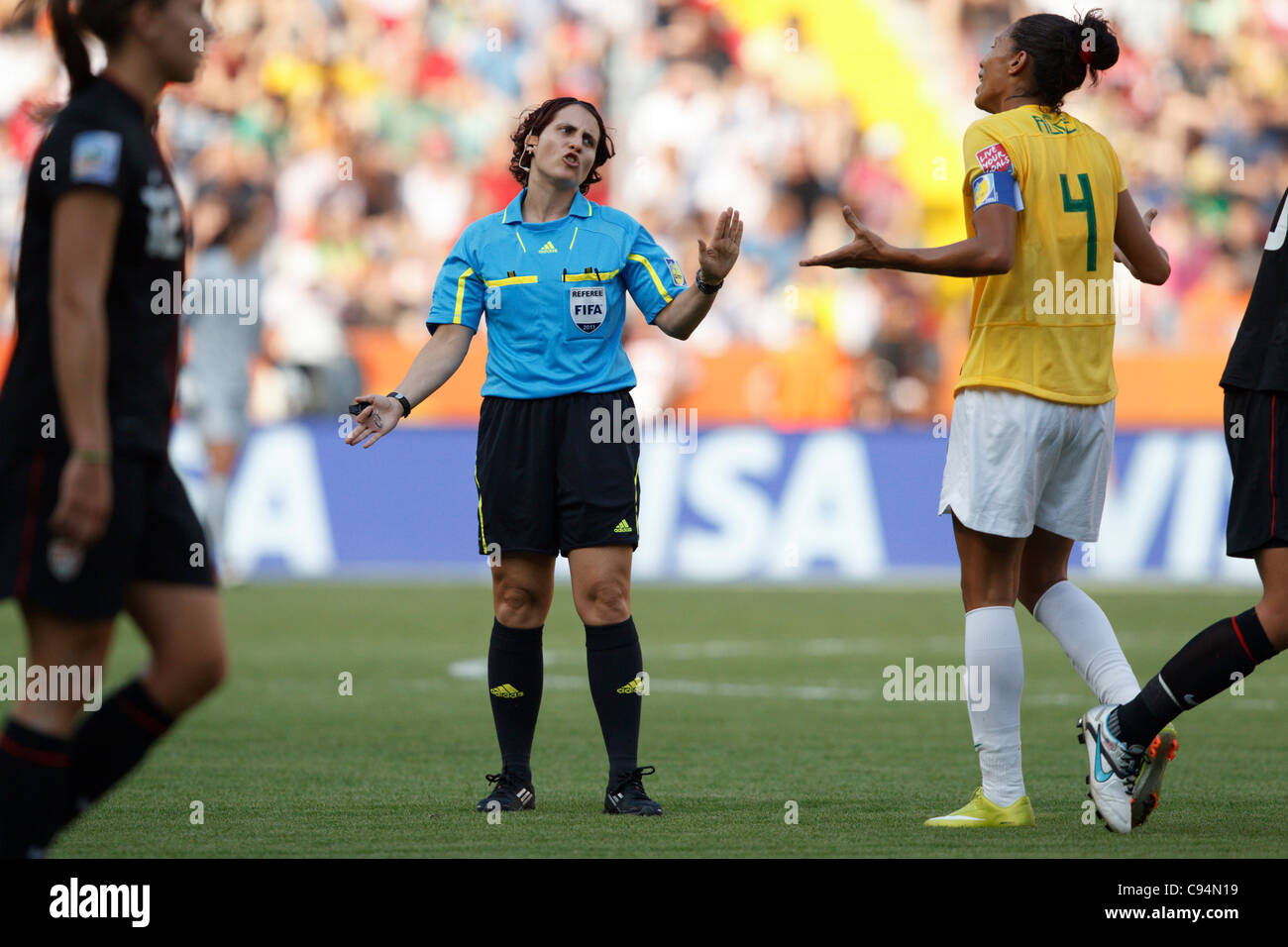 Aline of Brazil (R) argues with referee Jacqui Melksham (L) during a 2011 Women's World Cup quarterfinal match against the USA. Stock Photo