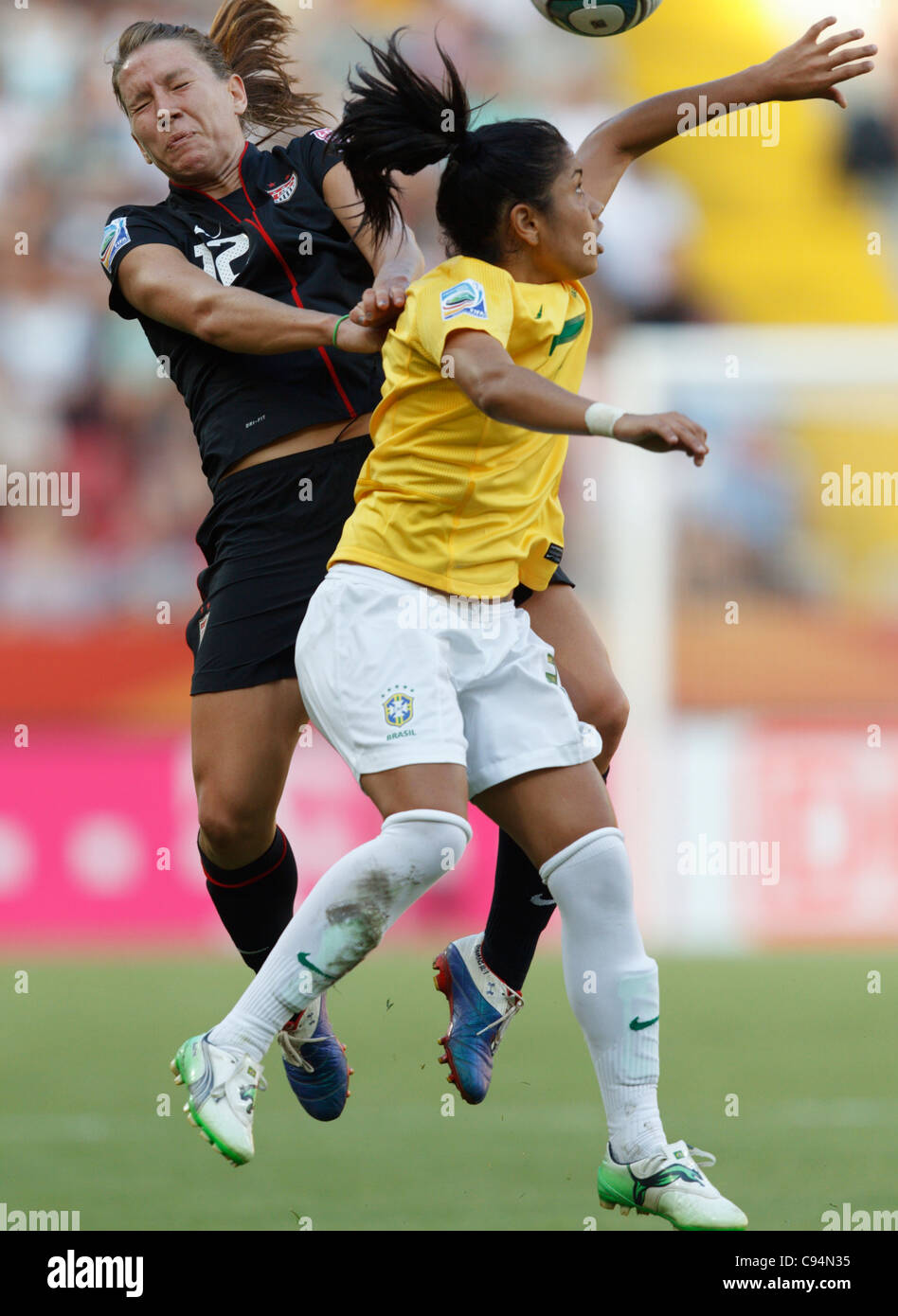 DRESDEN, GERMANY - JULY 10:  Lauren Cheney of the United States (L) and Maurine of Brazil (R) fight for a header during a FIFA Women's World Cup quarterfinal match at Rudolf Harbig Stadium on July 10, 2011 in Dresden, Germany. Editorial use only. Commercial use prohibited. (Photograph by Jonathan Paul Larsen / Diadem Images) Stock Photo