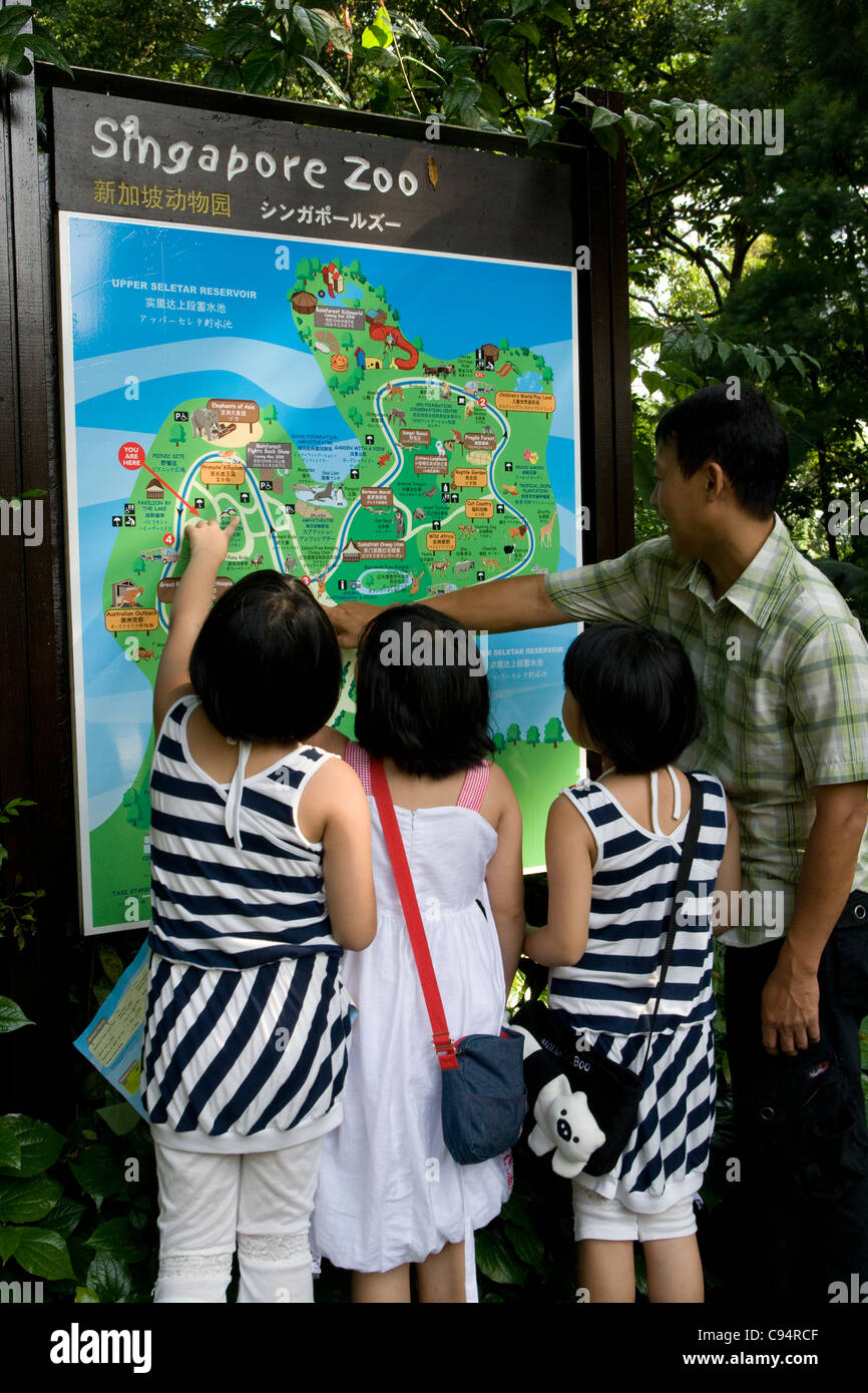 Singapore Zoo: family looking at zoo map Stock Photo