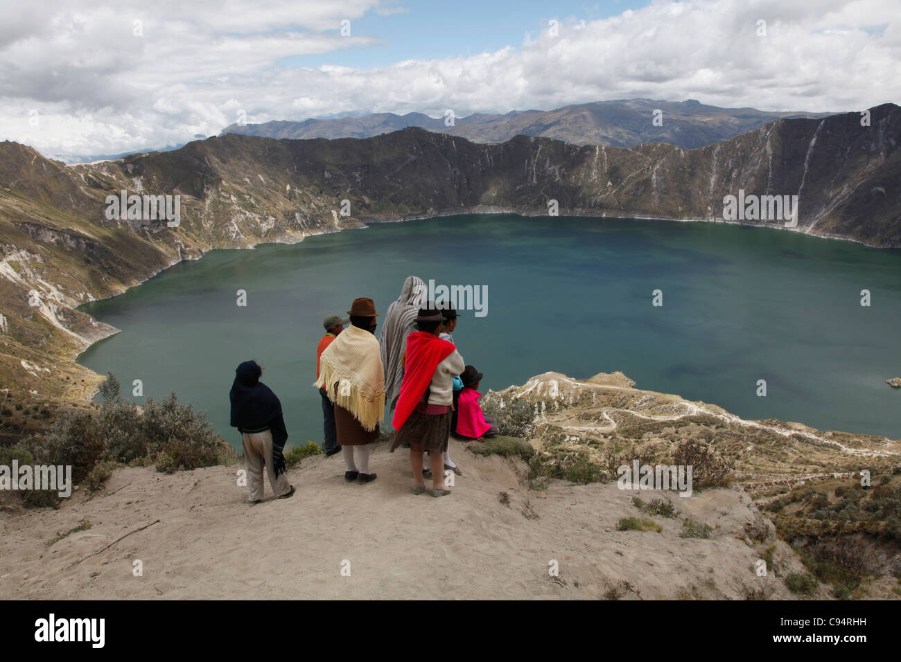 Tourists and local Quechua people by the shores of crater lake Quilotoa in the Andes region of Ecuador, South America Stock Photo