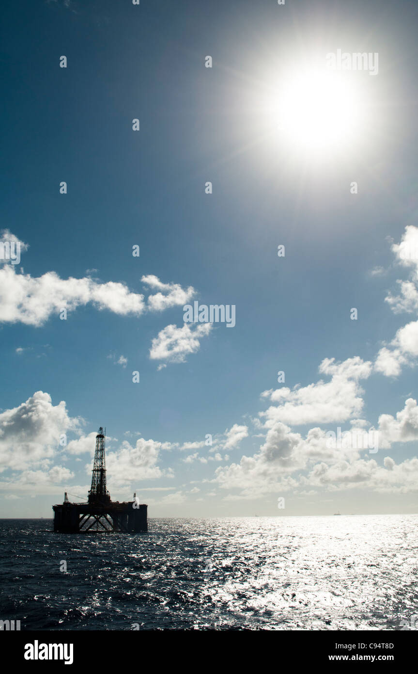 Oil drilling rig in offshore area, back light with high sun. Coast of ...