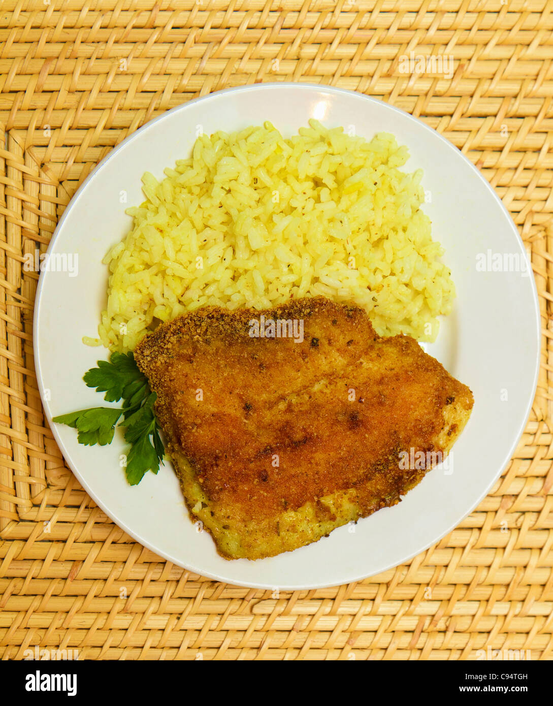 Fried Breaded Tilapia Served With Rice And Herbs Stock Photo - Alamy