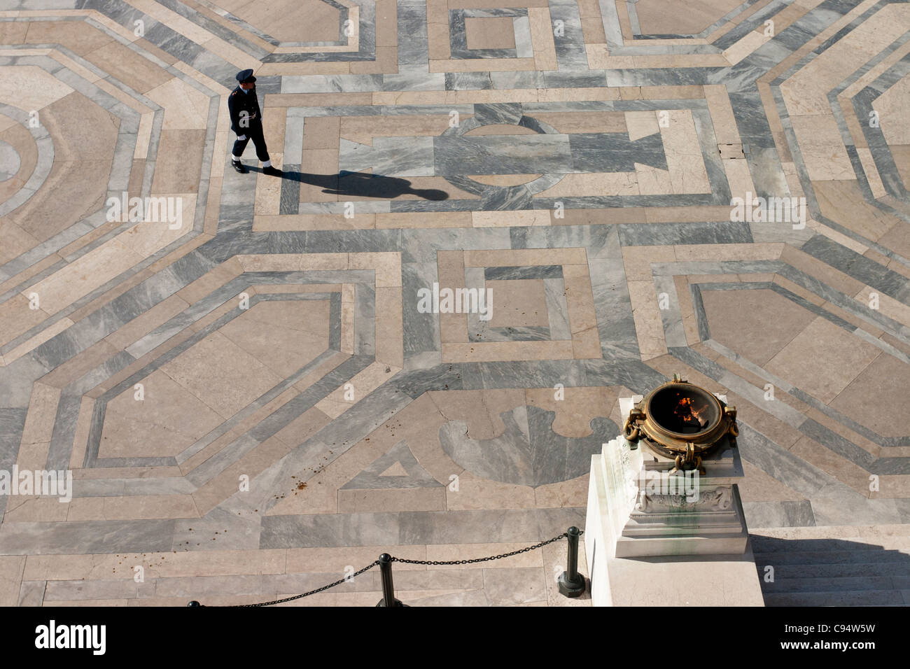 Honour Guard and Eternal Flame. One of the honor guards passes in front of the flame commemorating Italy's unknown soldier. Stock Photo