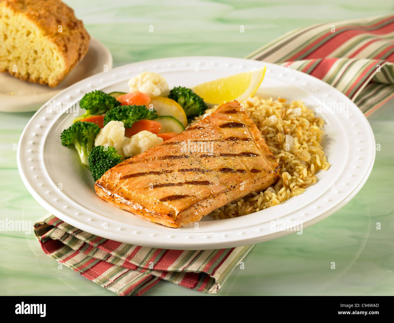Salmon dinner served with rice and vegetables Stock Photo
