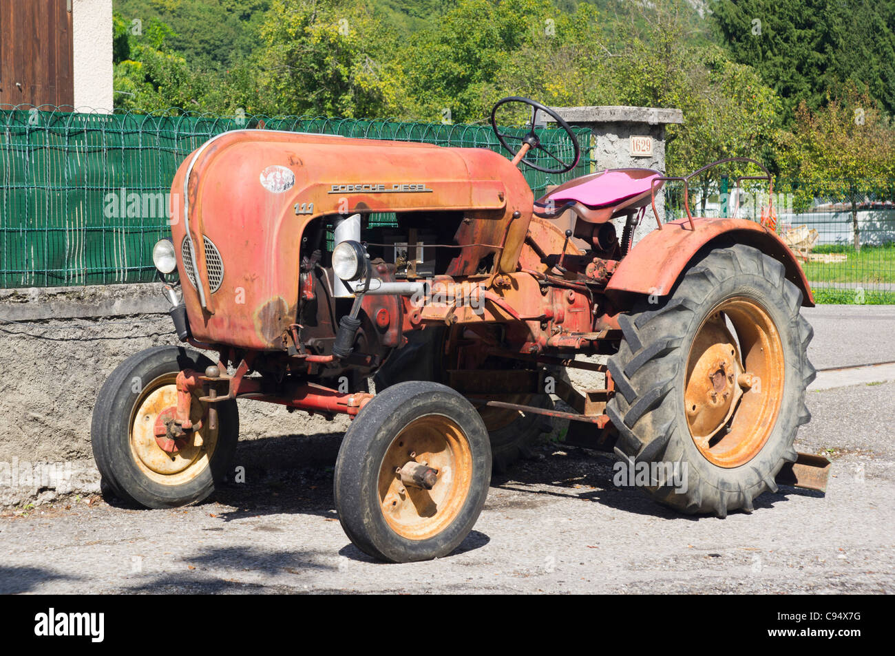 A 1950s Porsche 111 single cylinder diesel tractor parked outside a house  at Chaparon near Lake Annecy Stock Photo - Alamy