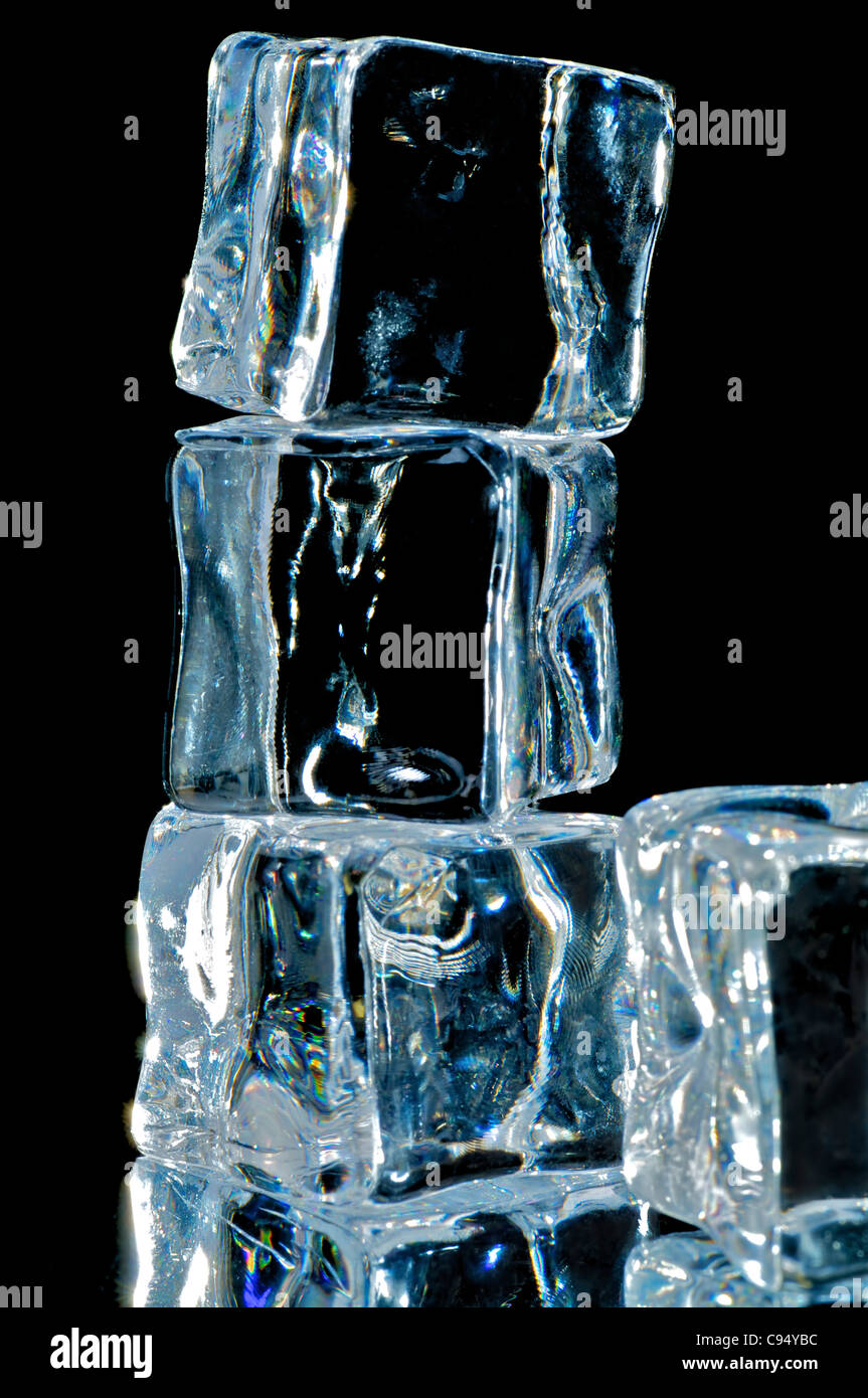 4 ice cube on the black background with reflection Stock Photo - Alamy