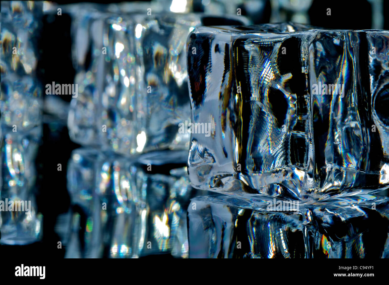 4 ice cube on the black background with reflection Stock Photo - Alamy