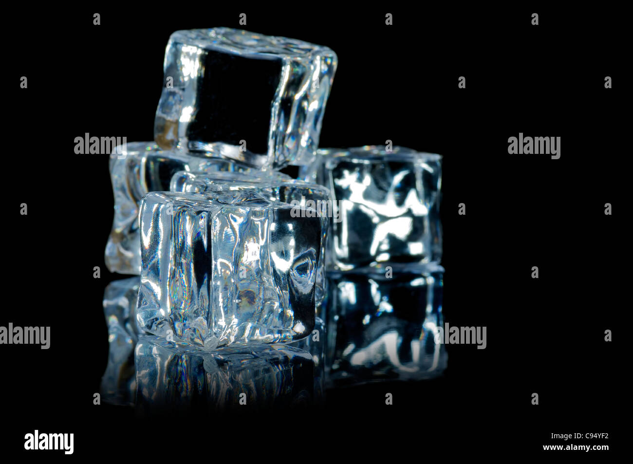 5 ice cube on the black background with reflection Stock Photo - Alamy