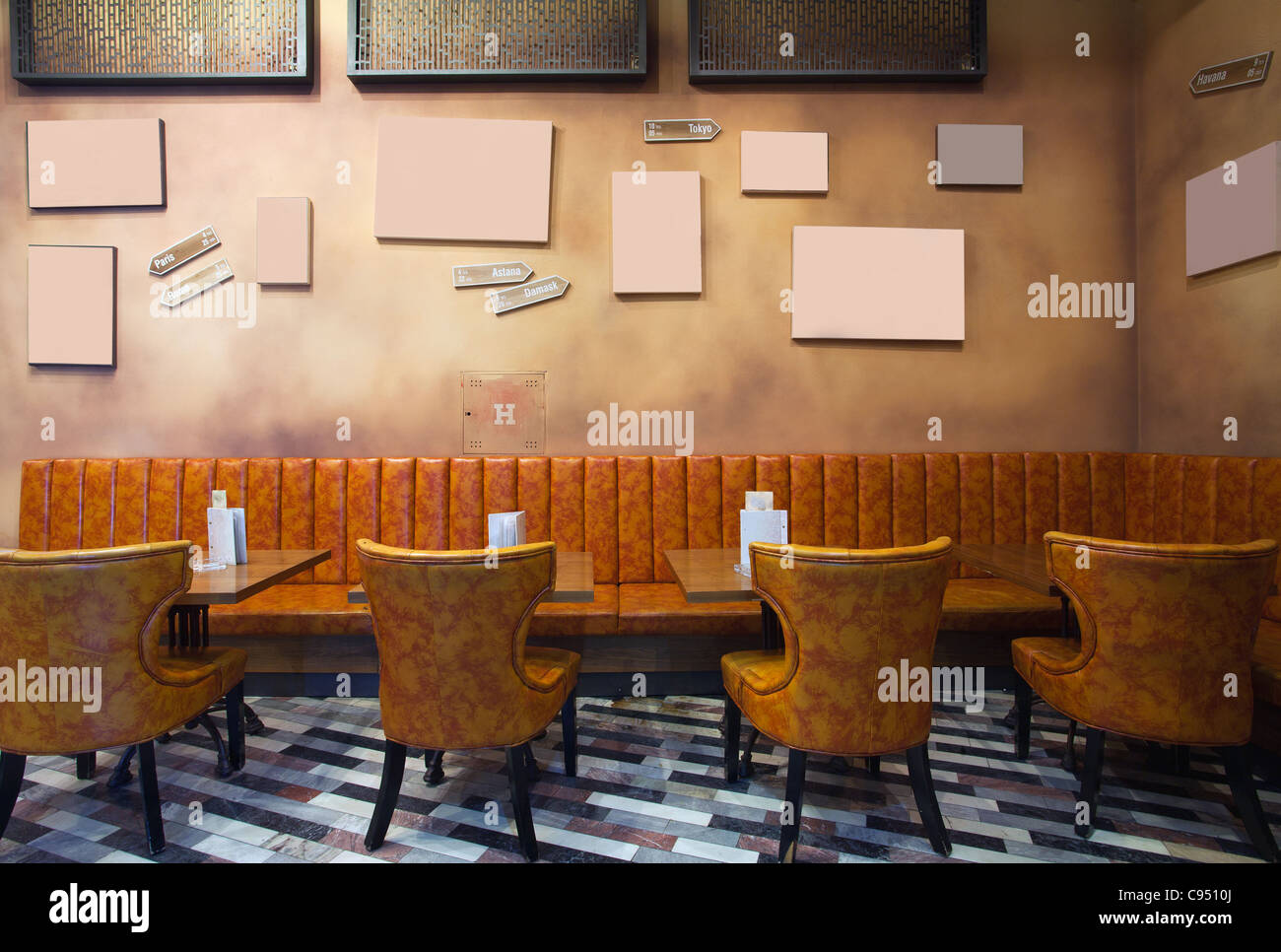 Restaurant interior, vintage style, leather armchairs and empty frames on the wall. Stock Photo
