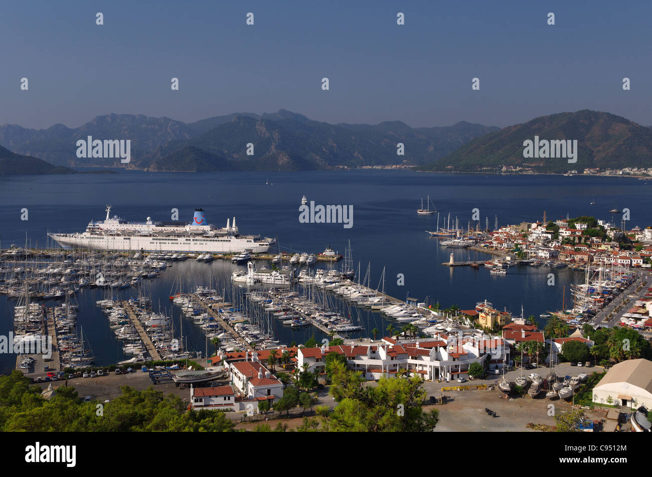 Port of Marmaris, Turkey. Old town with marina and cruise ship Thomson Celebration on quay. Stock Photo