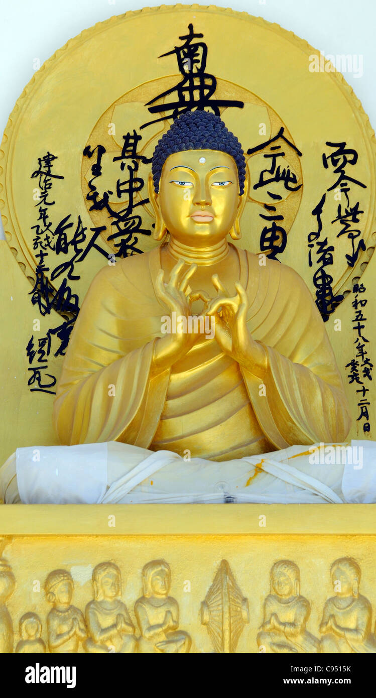 The main golden image of the Buddha on the dome of the  Shanti Stupa. Shanti Stupa is a peace stupa built to promote world peace Stock Photo