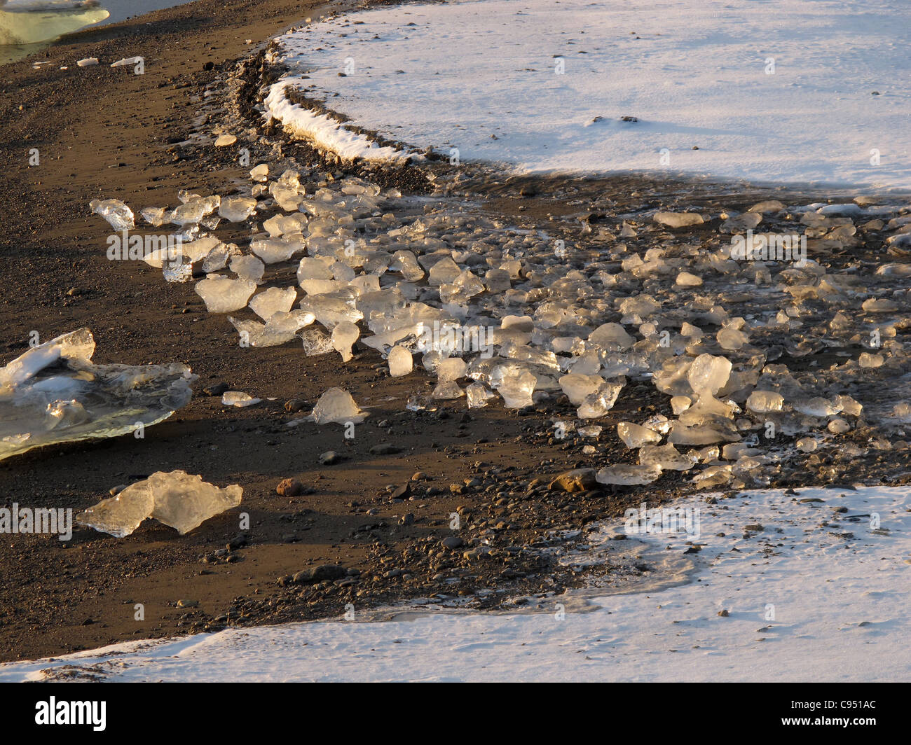 Ice at a beach lighted up during sunrise, Recherchebreen, Spitsbergen Stock Photo