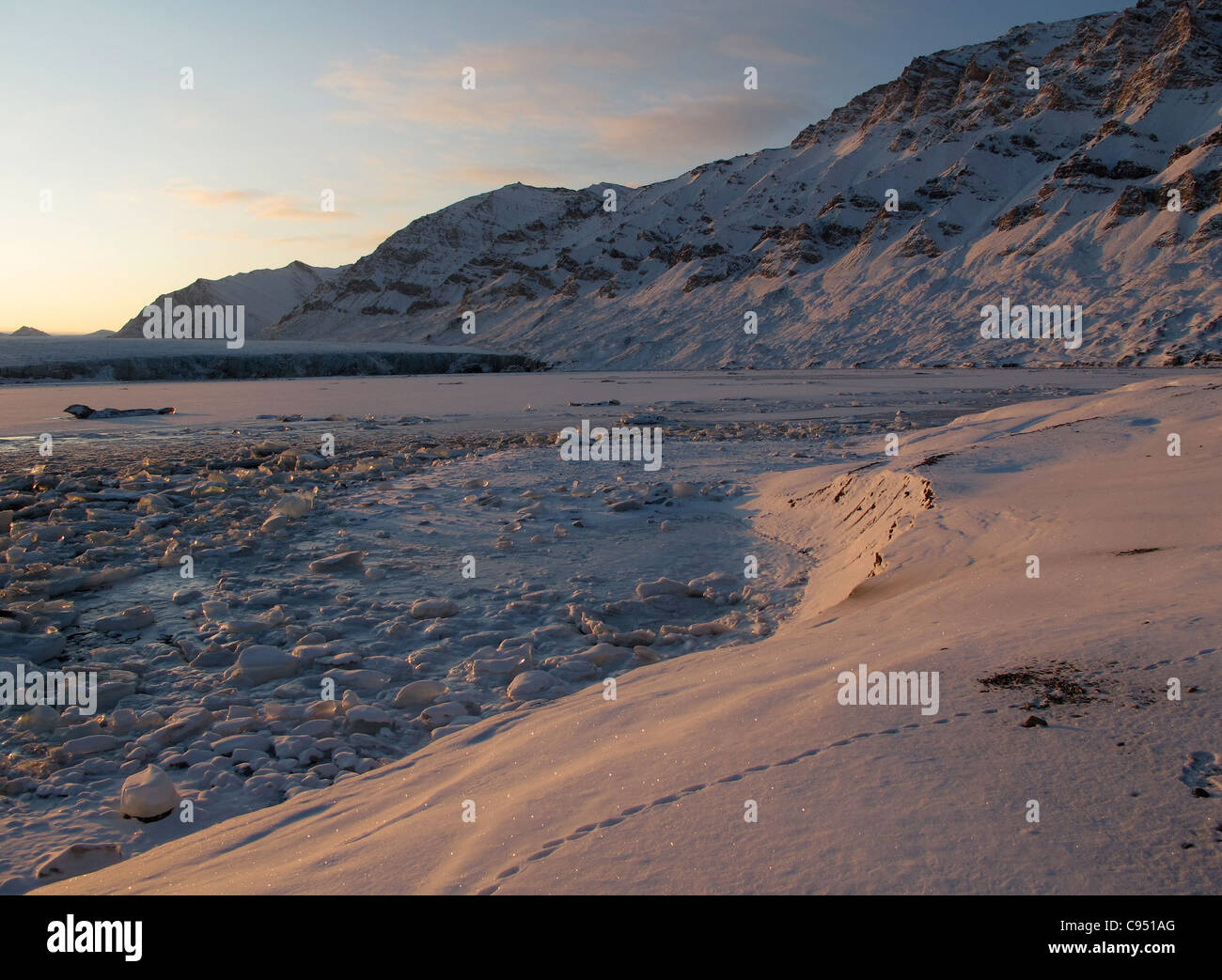 Ice and snow in front of the glacier lighted up during sunrise, Recherchebreen, Spitsbergen Stock Photo