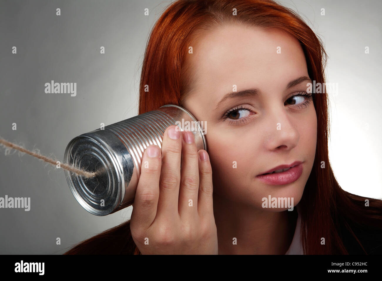 woman using a tin can on the end of a piece of string Stock Photo Alamy