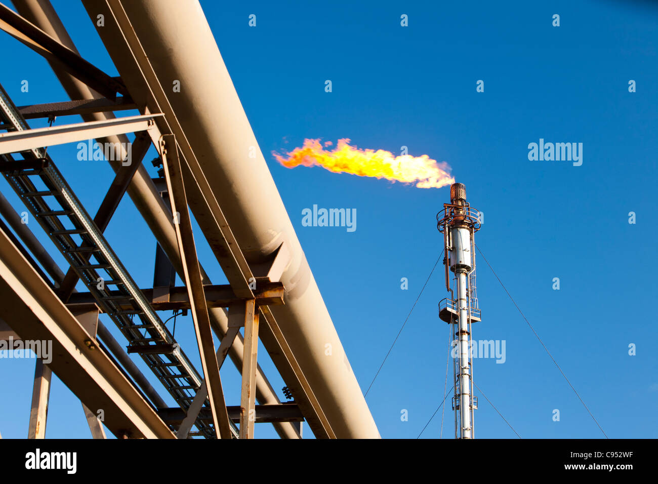 Flaring of waste gas at Flotta oil terminal in the Orkney's Scotland, UK. Stock Photo