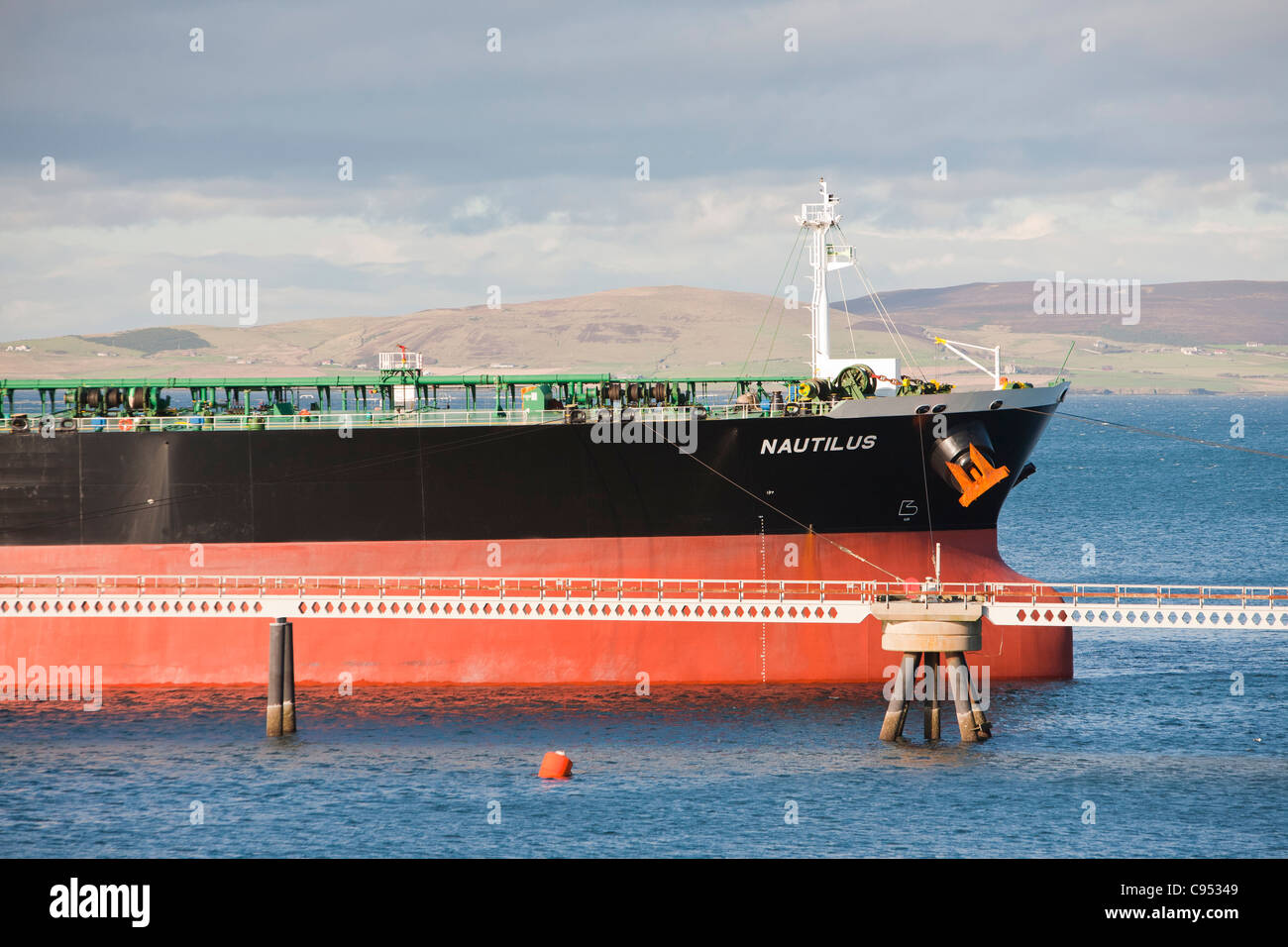 An oil tanker loading with crude oil at the Flotta oil terminal in the Orkney islands, Scotland, UK. Stock Photo
