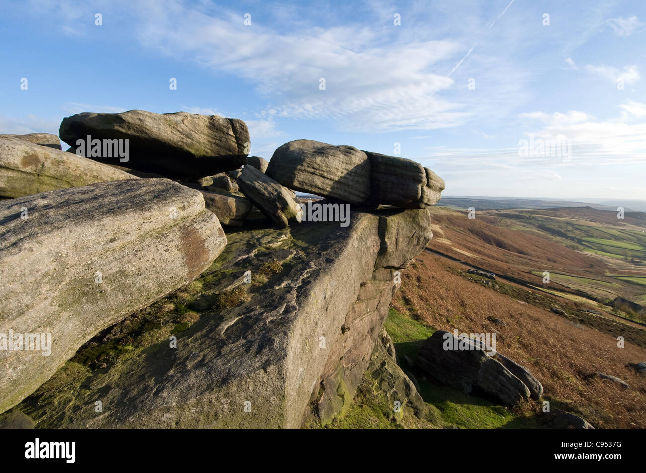 Stanage Edge Gritstone Rocks in the Peak District National Park Derbyshire shot against Blue skies Stock Photo