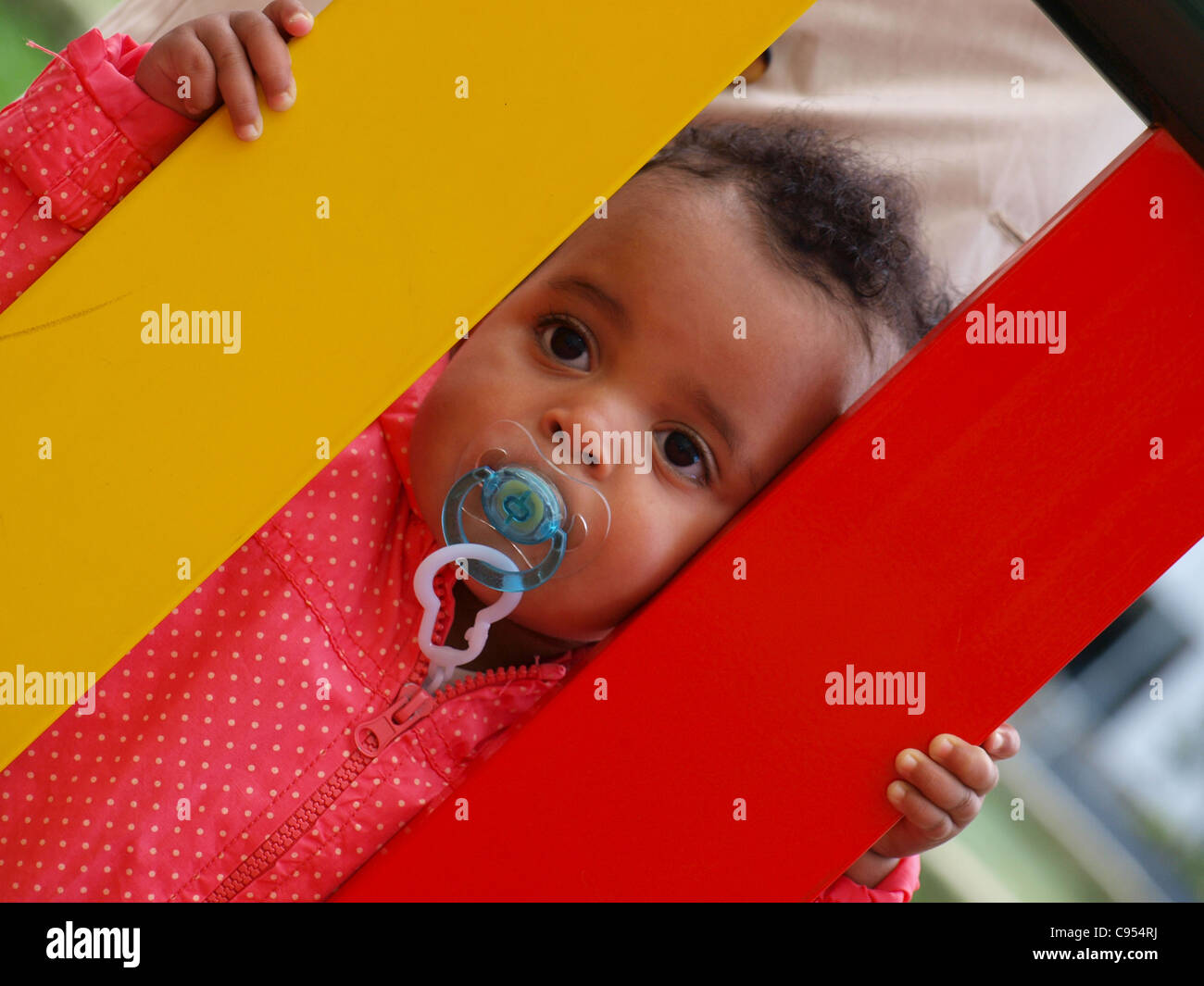 Infant with a pacifier in a playground, Vigo, Spain Stock Photo Alamy