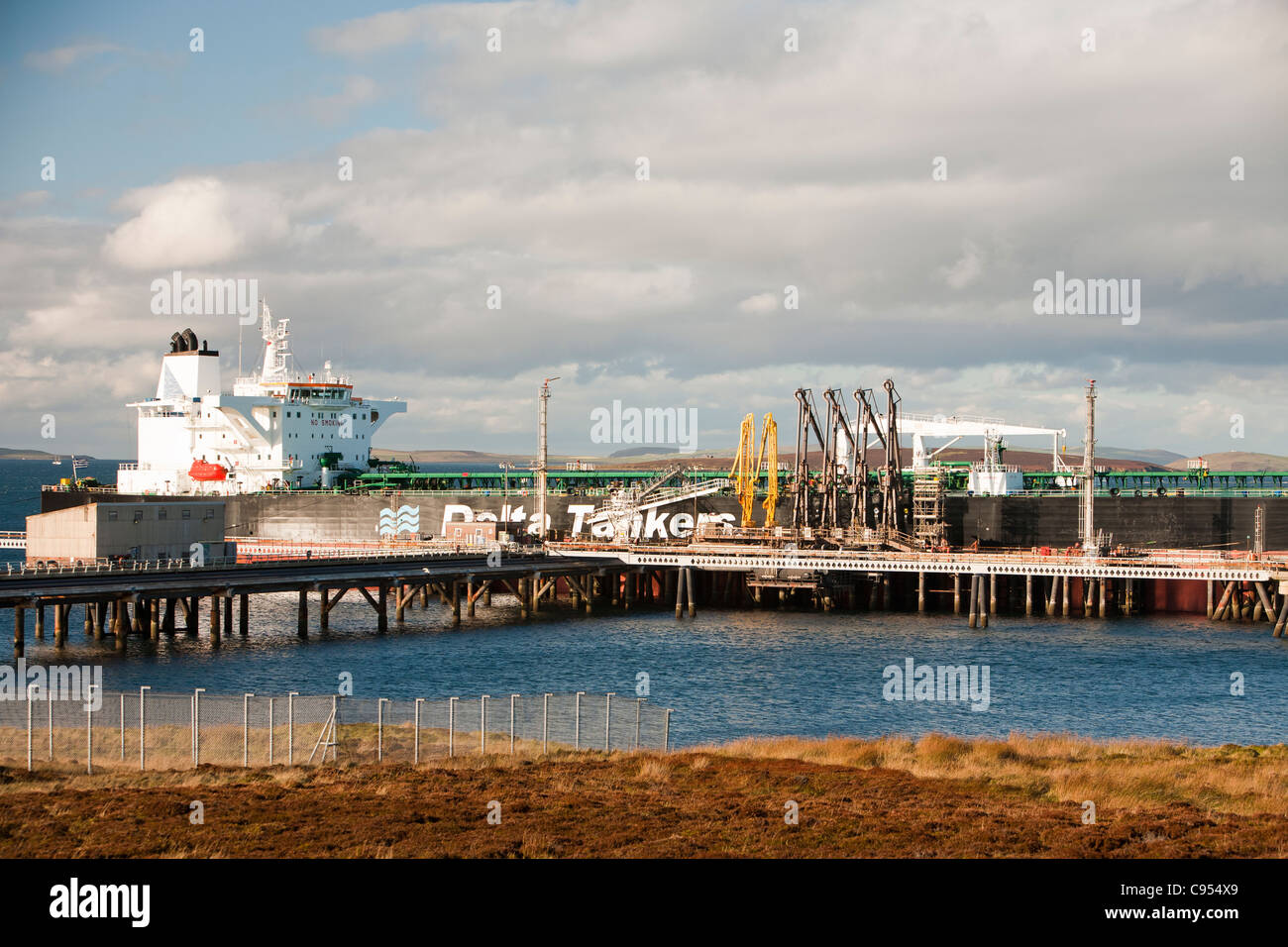 An oil tanker loading with crude oil at the Flotta oil terminal in the Orkney islands, Scotland, UK. Stock Photo
