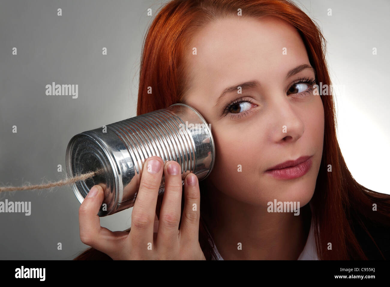woman using a tin can on the end of a piece of string Stock Photo Alamy