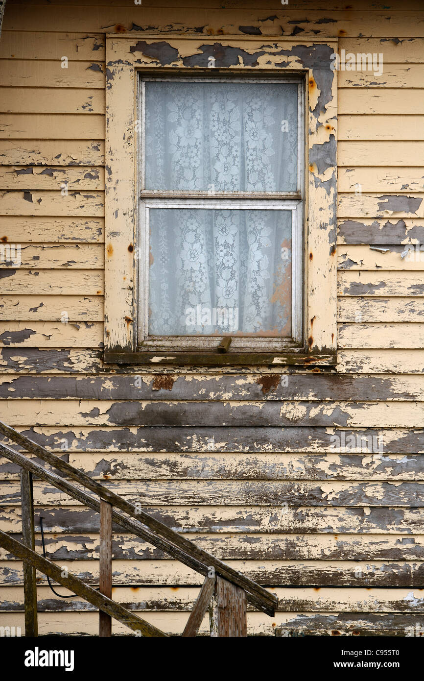 Window with curtains in a wooden house in Saint George island, Pribilof Islands, Alaska, USA Stock Photo