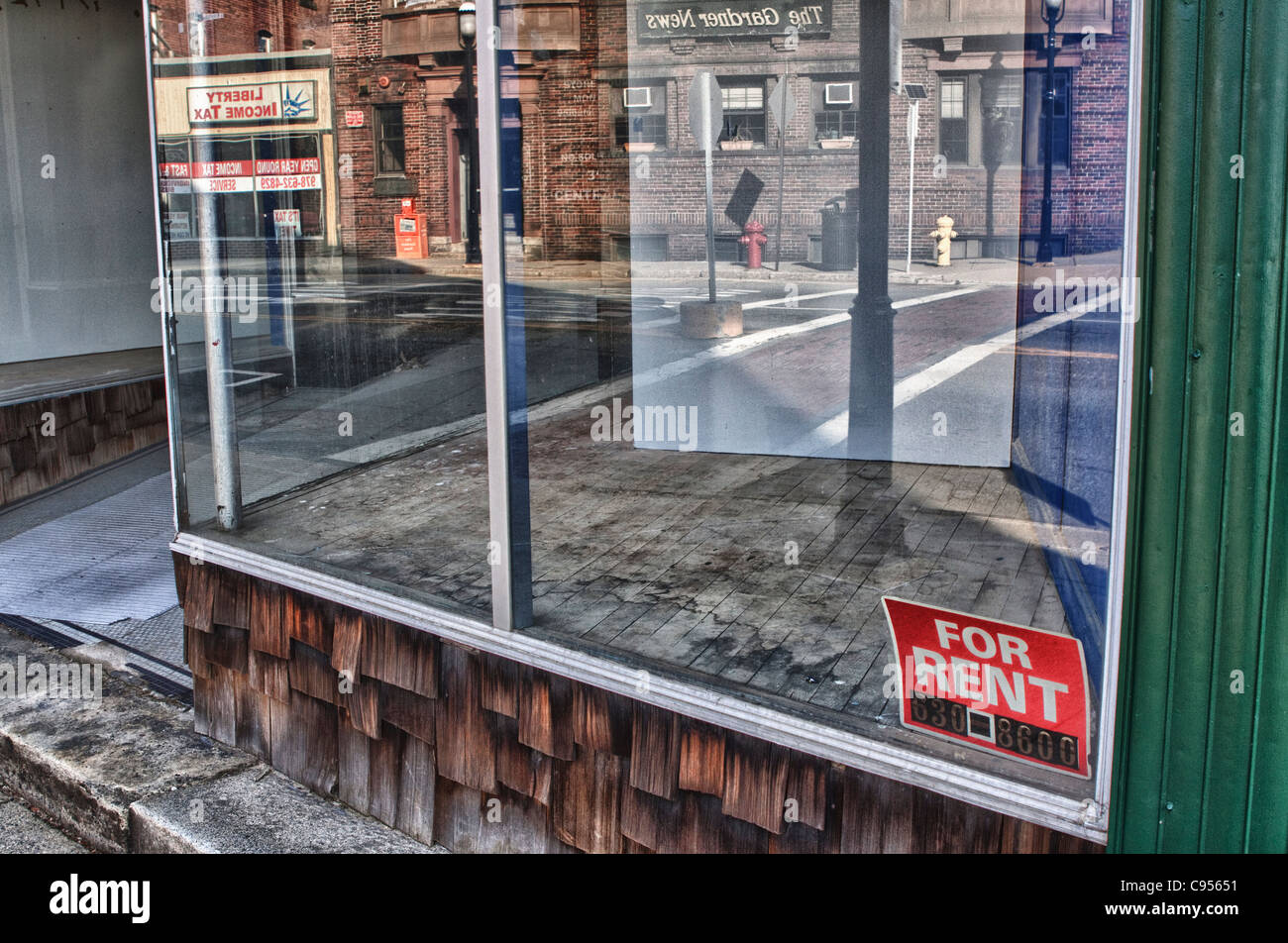 For Rent sign in an empty downtown retail store Stock Photo