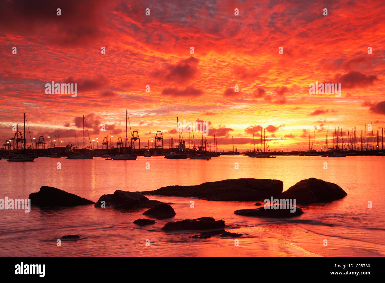 Dramatic sunrise from Alcaravaneras beach in Las Palmas, Gran Canaria,  Canary Islands, Spain. Anchored yachts in background Stock Photo - Alamy