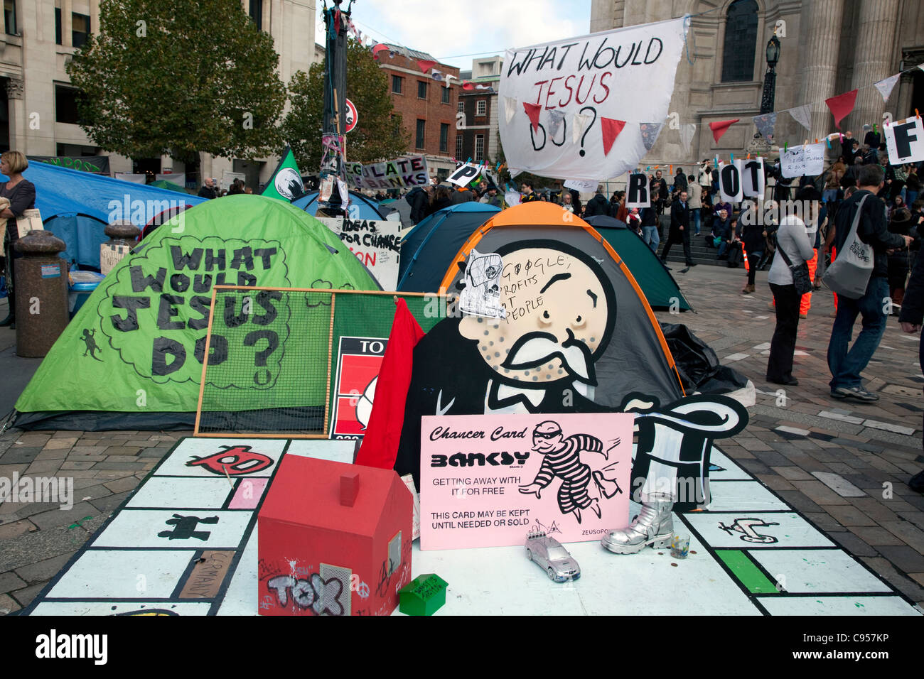 Occupy London anti-capitalism protest camp outside St Paul's Cathedral, London with Monopoly board by Banksy Stock Photo