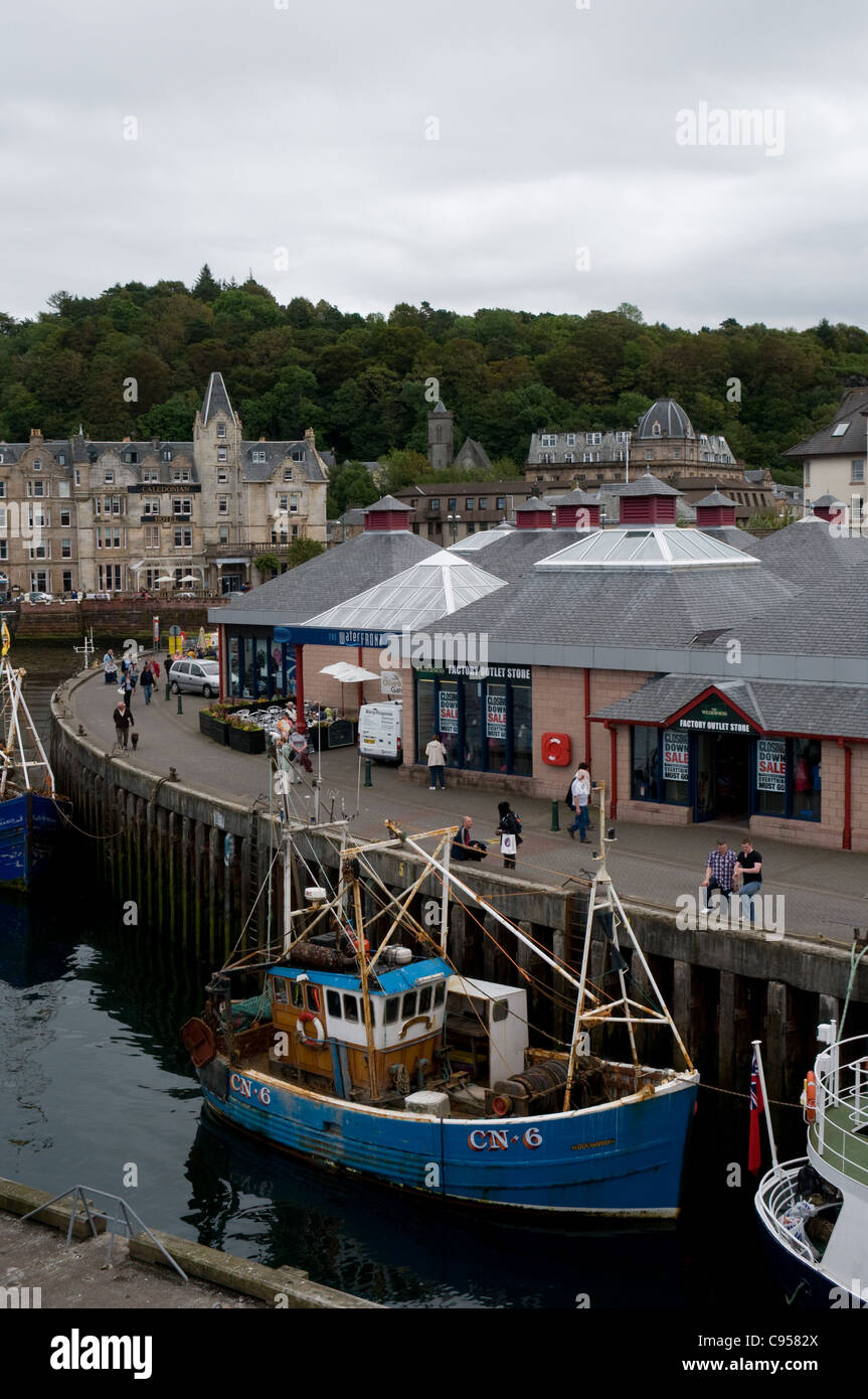 A fishing boat is moored alongside the quayside in Oban , Sutherland