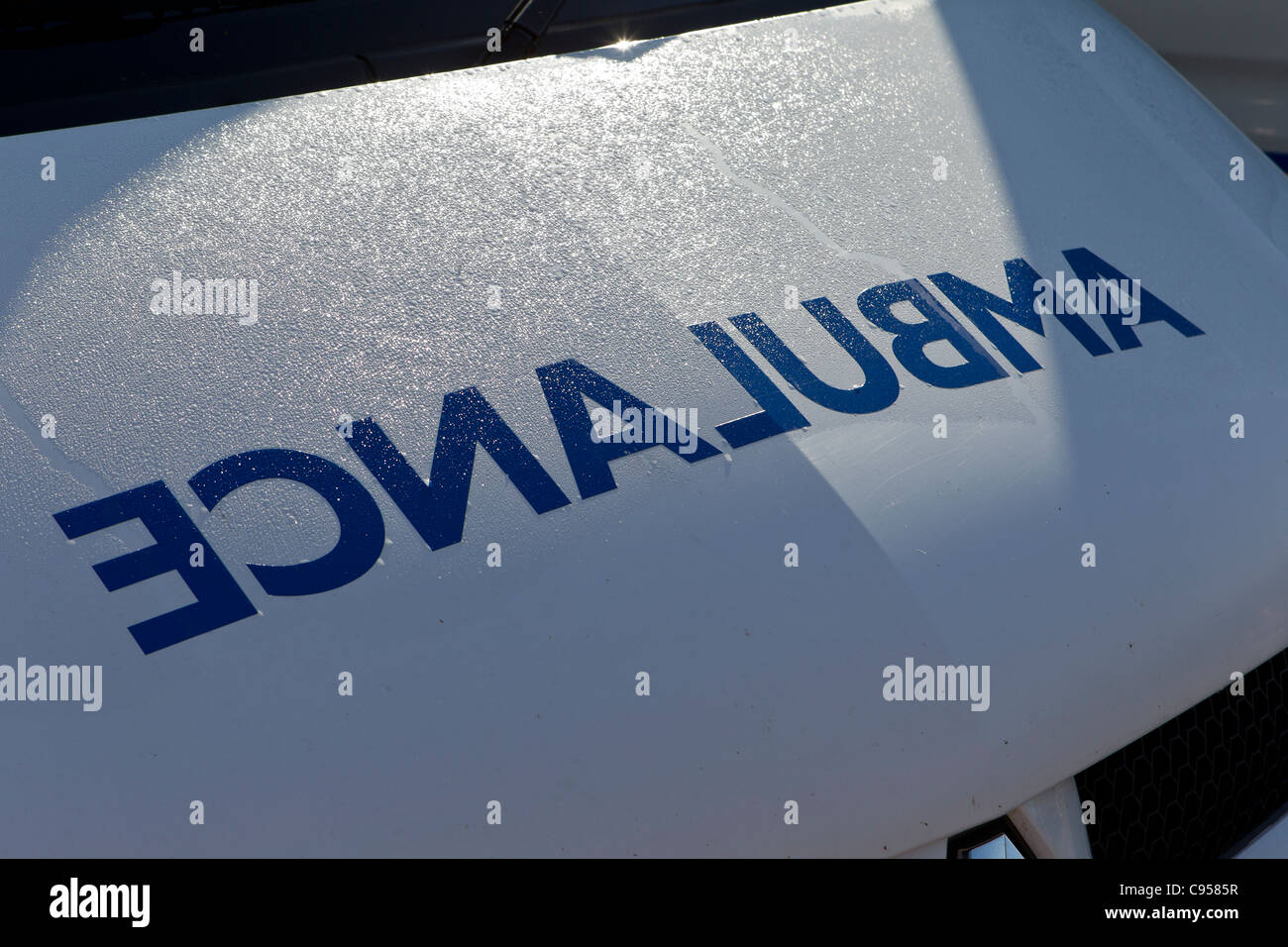 Detail of the front of an ambulance with the word AMBULANCE as a mirror image Stock Photo