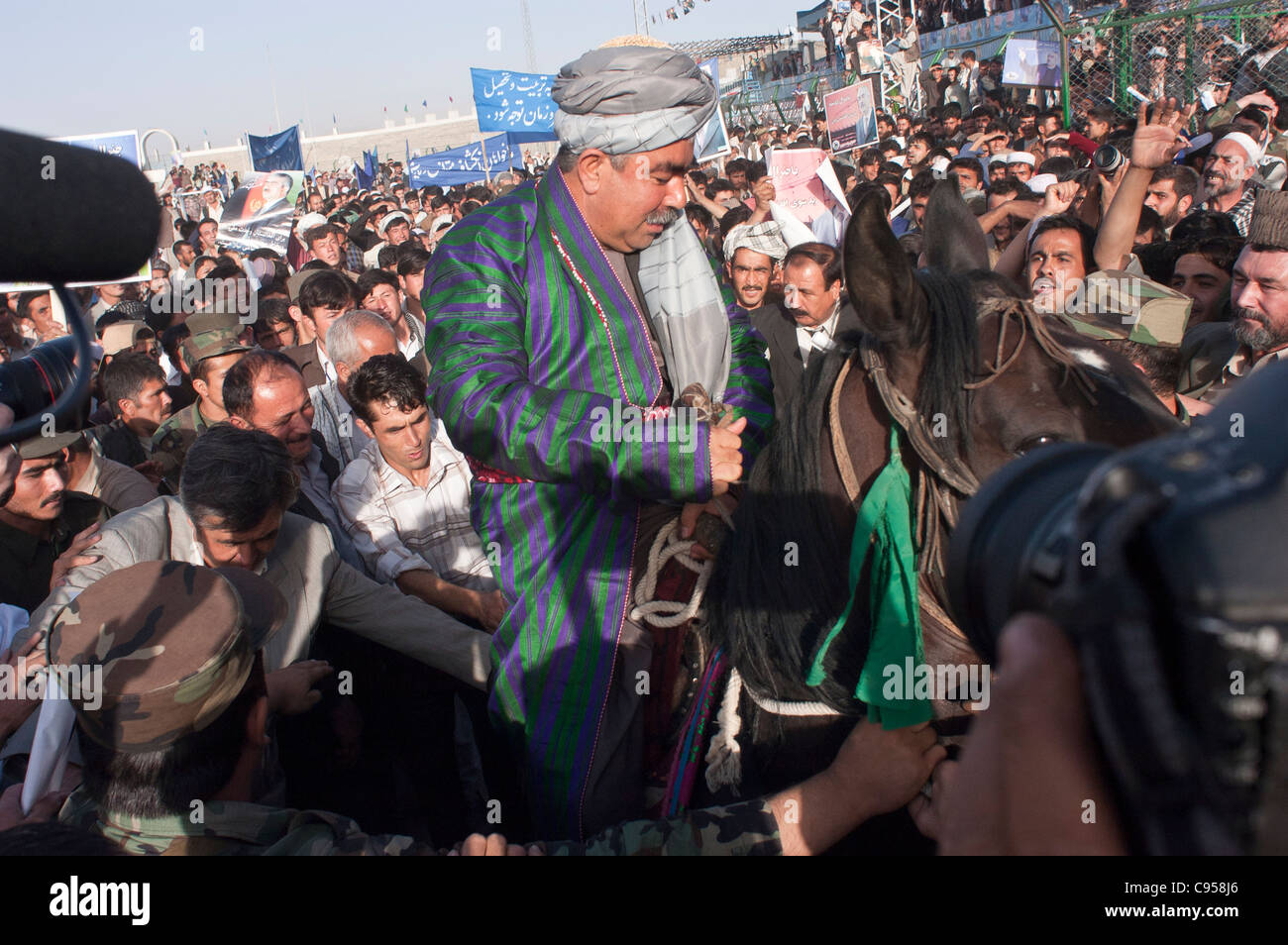 Afghan Uzbek commander and Presidential candidate Abdul Rashid Dostum sits on his horse during a campaign rally in Kabul stadium Stock Photo